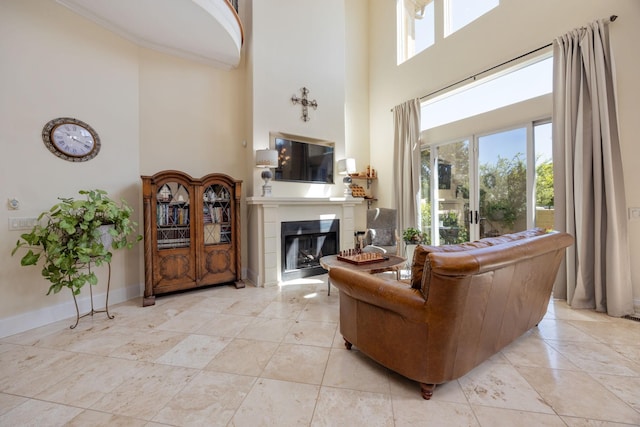 891 Fairington Pvt Way, Gallatin, TN 37066 - living area with a high ceiling, a glass covered fireplace, healthy amount of natural light, and baseboards