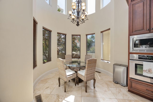 891 Fairington Pvt Way, Gallatin, TN 37066 - dining area featuring a chandelier, baseboards, and a high ceiling
