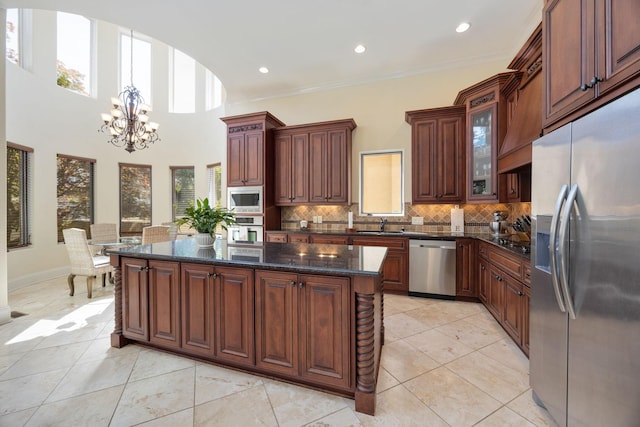 891 Fairington Pvt Way, Gallatin, TN 37066 - kitchen with appliances with stainless steel finishes, a chandelier, tasteful backsplash, a center island, and glass insert cabinets