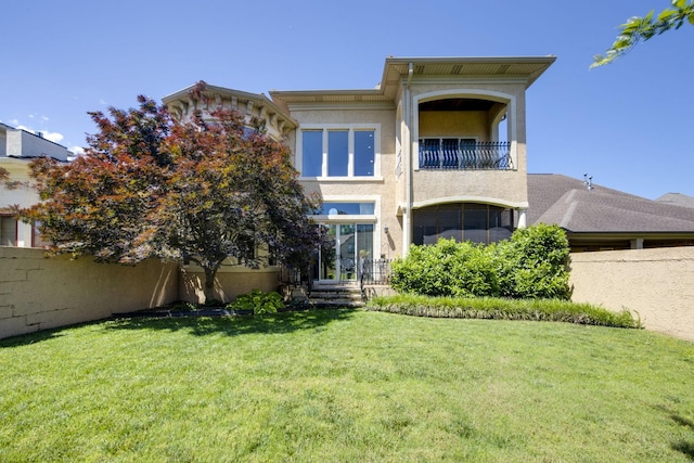 891 Fairington Pvt Way, Gallatin, TN 37066 - back of house featuring a balcony, a lawn, and stucco siding