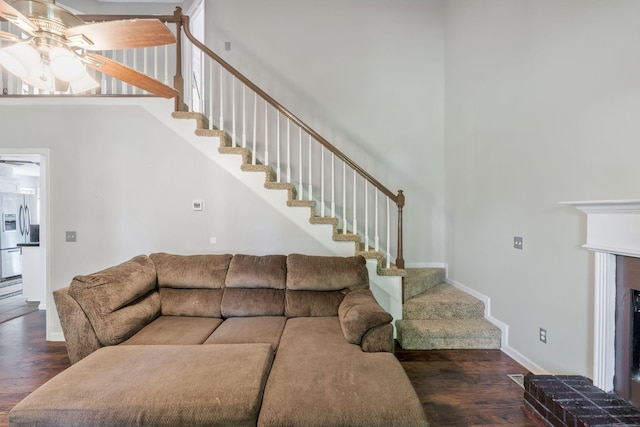 1012 Blue Ridge Pkwy, Goodlettsville, TN 37072 - living area featuring ceiling fan, wood finished floors, a high ceiling, stairs, and baseboards
