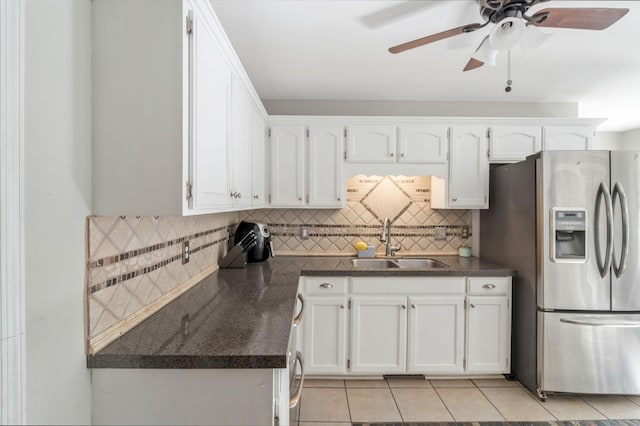 1012 Blue Ridge Pkwy, Goodlettsville, TN 37072 - kitchen featuring stainless steel fridge with ice dispenser, a sink, dark countertops, and white cabinets