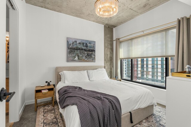 600 12th Ave S Unit 1208, Nashville, TN 37203 - bedroom featuring a chandelier and baseboards