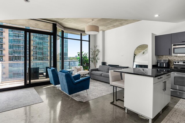 600 12th Ave S Unit 1208, Nashville, TN 37203 - living area with floor to ceiling windows, concrete floors, and arched walkways