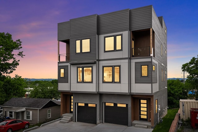 6104 Cowden Ave Unit A, Nashville, TN 37209 - contemporary house with an attached garage, concrete driveway, a balcony, and stucco siding