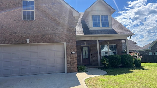 1026 Grace Meade, Ashland City, TN 37015 - view of front of property featuring brick siding, a front lawn, covered porch, and driveway
