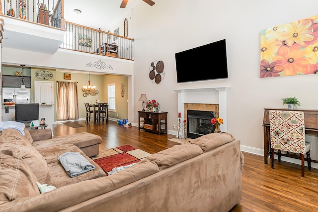 1026 Grace Meade, Ashland City, TN 37015 - living area featuring wood finished floors, a chandelier, ceiling fan, a fireplace with flush hearth, and baseboards