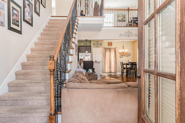 1026 Grace Meade, Ashland City, TN 37015 - staircase with a high ceiling, a chandelier, and baseboards