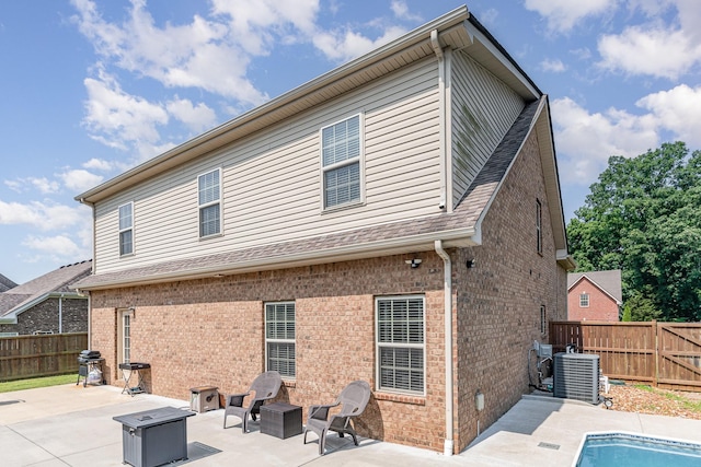1026 Grace Meade, Ashland City, TN 37015 - rear view of house with a patio, brick siding, a fenced backyard, and central AC