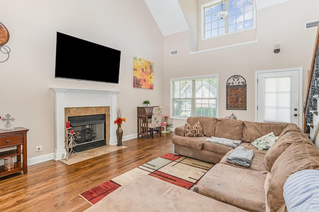 1026 Grace Meade, Ashland City, TN 37015 - living area with wood finished floors, a high ceiling, baseboards, and a tiled fireplace
