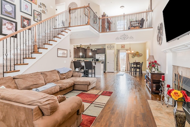 1026 Grace Meade, Ashland City, TN 37015 - living room featuring a high ceiling, light wood-style flooring, stairs, and a chandelier