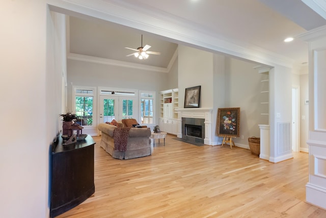 205 Saint Anne Way, Franklin, TN 37064 - living room featuring crown molding, a ceiling fan, light wood finished floors, a fireplace, and high vaulted ceiling