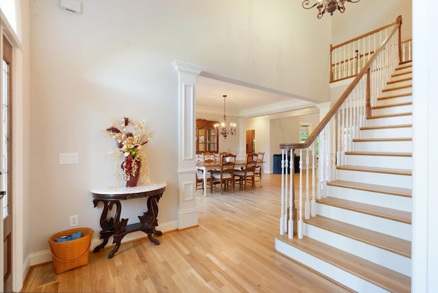 205 Saint Anne Way, Franklin, TN 37064 - foyer entrance with a chandelier, a towering ceiling, stairs, light wood finished floors, and healthy amount of natural light