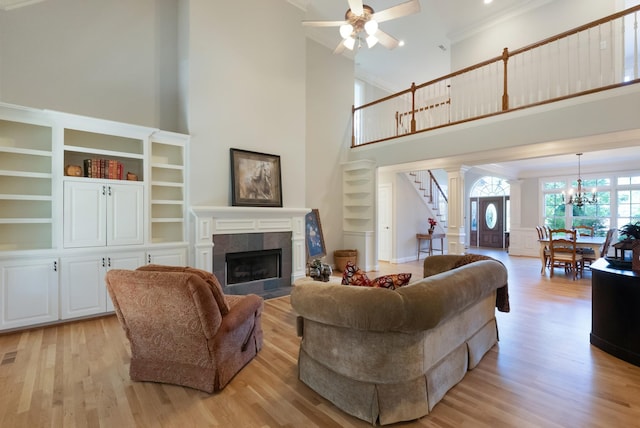 205 Saint Anne Way, Franklin, TN 37064 - living area with a towering ceiling, light wood-style flooring, stairway, a ceiling fan, and a tile fireplace