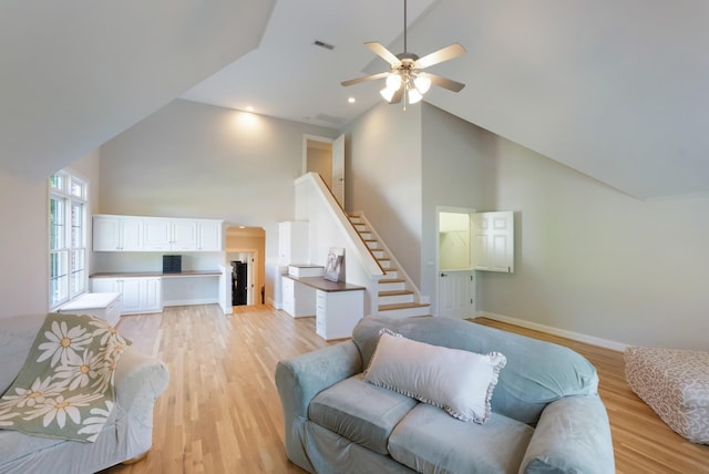 205 Saint Anne Way, Franklin, TN 37064 - living room featuring high vaulted ceiling, ceiling fan, stairs, light wood-type flooring, and baseboards
