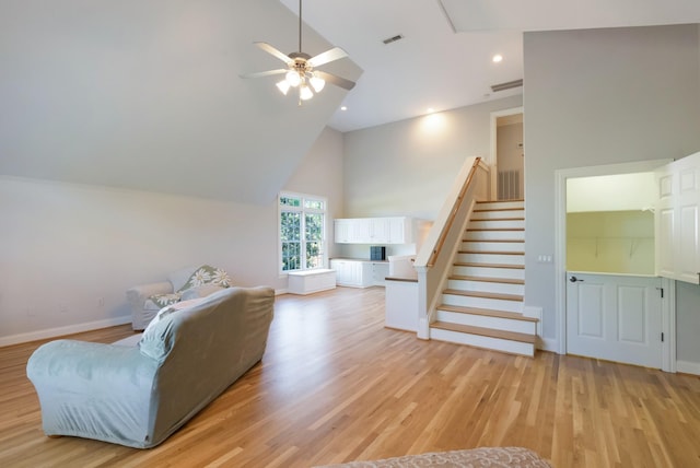 205 Saint Anne Way, Franklin, TN 37064 - living room with high vaulted ceiling, ceiling fan, stairway, light wood-style flooring, and baseboards