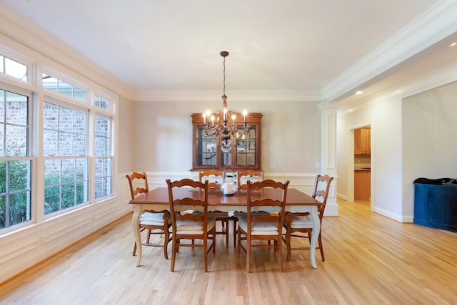 205 Saint Anne Way, Franklin, TN 37064 - dining room with a chandelier, healthy amount of natural light, light wood-style flooring, ornamental molding, and wainscoting