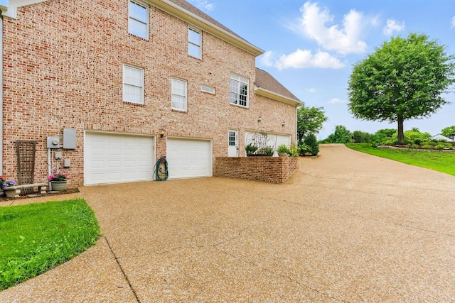 205 Saint Anne Way, Franklin, TN 37064 - view of property exterior with an attached garage, driveway, and brick siding