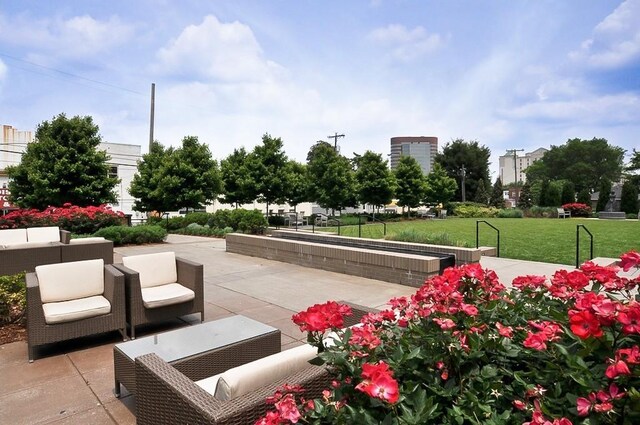 900 20th Ave S Unit 909, Nashville, TN 37212 - surrounding community with outdoor lounge area, a patio area, and a yard