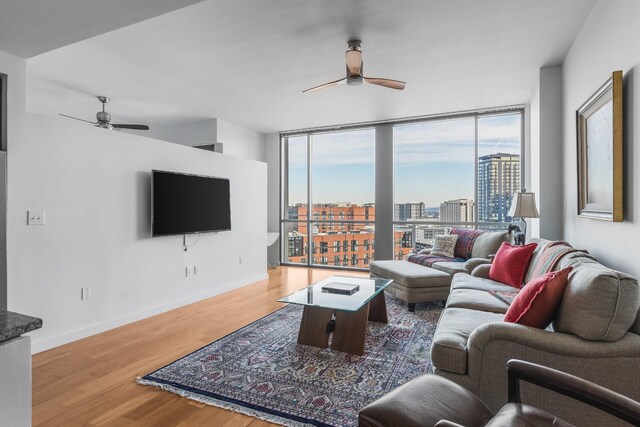 900 20th Ave S Unit 909, Nashville, TN 37212 - living area with a ceiling fan, plenty of natural light, wood finished floors, and expansive windows