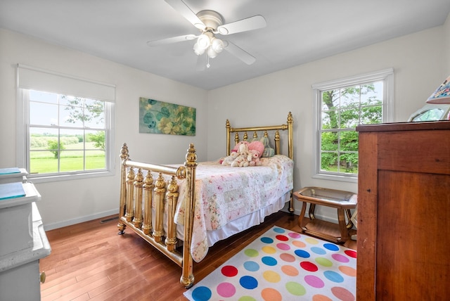 1711 Lovers Ln, Hopkinsville, KY 42240 - bedroom with multiple windows, wood finished floors, baseboards, and a ceiling fan