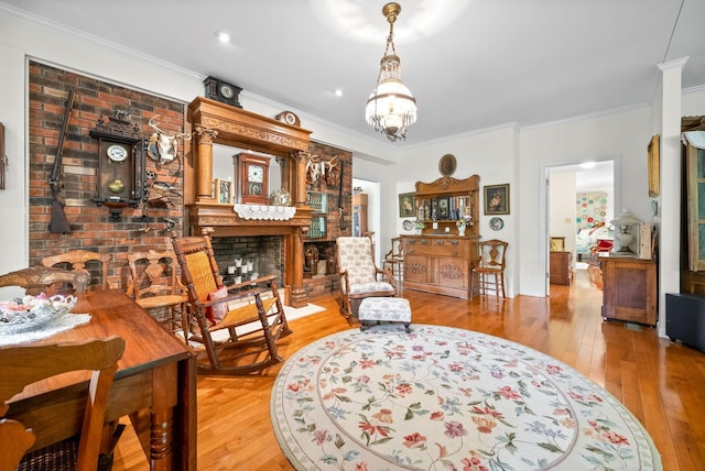 1711 Lovers Ln, Hopkinsville, KY 42240 - living area with ornamental molding, light wood-style floors, a fireplace, and a chandelier