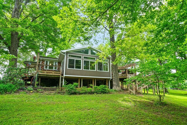 1711 Lovers Ln, Hopkinsville, KY 42240 - back of property featuring stairway, a sunroom, a deck, and a lawn