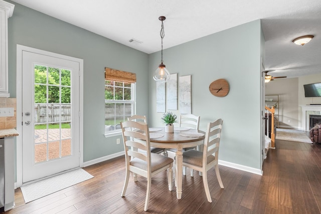 3182 Tristan Dr, Franklin, TN 37064 - dining area with dark wood finished floors, baseboards, a fireplace, and ceiling fan