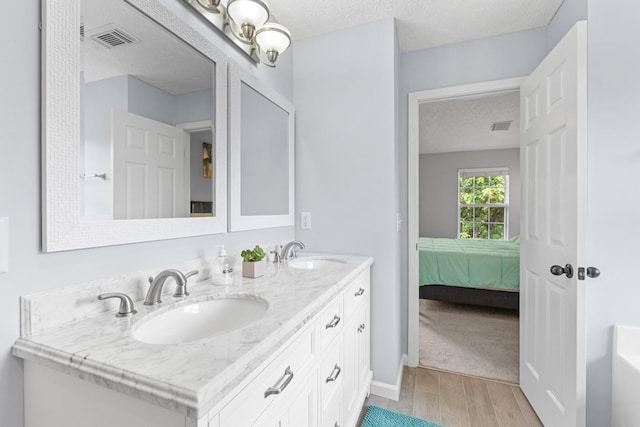 3182 Tristan Dr, Franklin, TN 37064 - full bath featuring double vanity, wood finished floors, ensuite bathroom, a bathtub, and baseboards