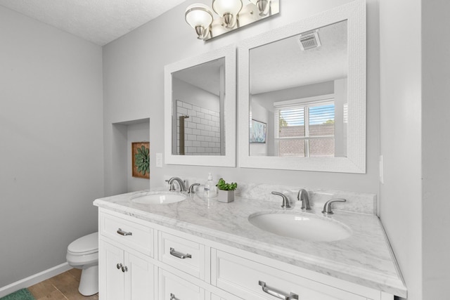 3182 Tristan Dr, Franklin, TN 37064 - full bathroom with a textured ceiling, toilet, double vanity, and baseboards