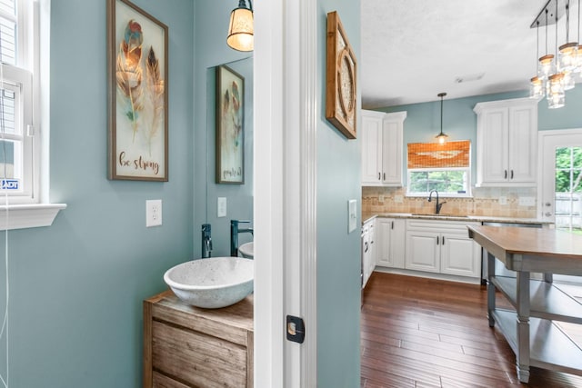 3182 Tristan Dr, Franklin, TN 37064 - kitchen with a sink, tasteful backsplash, white cabinetry, and hanging light fixtures
