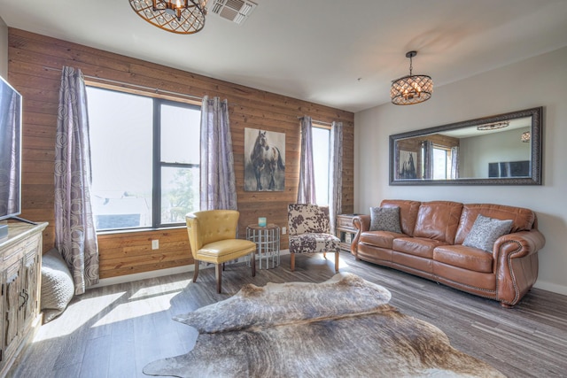 1900 12th Ave S Unit 406, Nashville, TN 37203 - living room featuring wood finished floors, a chandelier, baseboards, and wood walls
