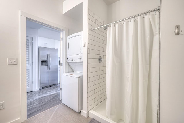 1900 12th Ave S Unit 406, Nashville, TN 37203 - bathroom with estacked washer and dryer and a tile shower