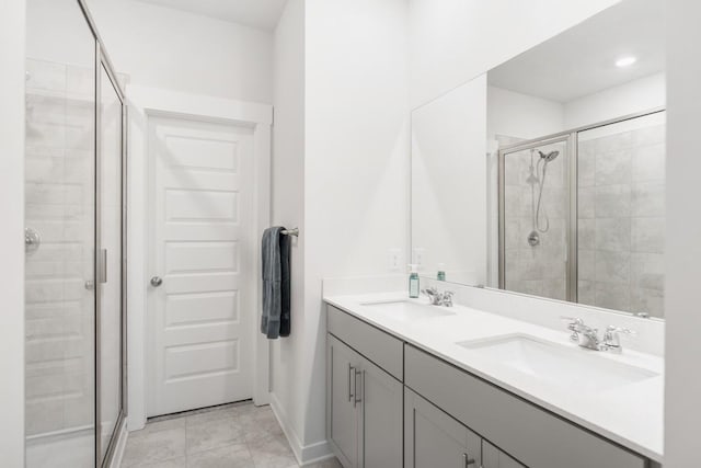 535 Ballard Dr, White House, TN 37188 - full bathroom with a stall shower, double vanity, and baseboards