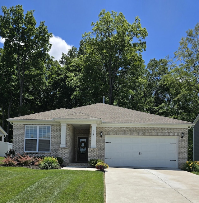 535 Ballard Dr, White House, TN 37188 - view of front of property featuring brick siding, concrete driveway, a garage, and a front yard