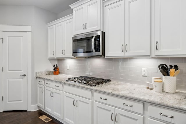 1151 Cotillion Dr, Murfreesboro, TN 37128 - kitchen with stainless steel appliances, white cabinetry, backsplash, and dark wood-type flooring