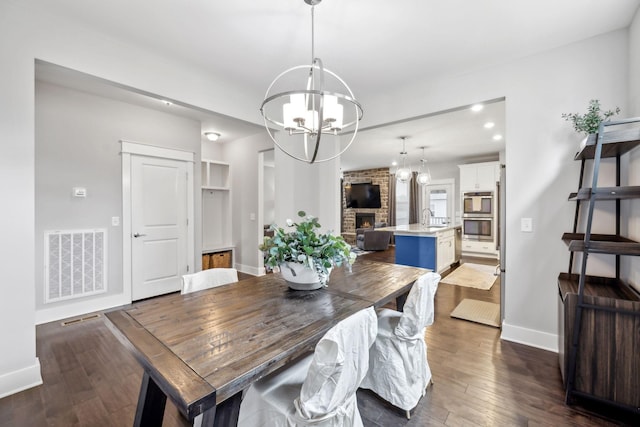 1151 Cotillion Dr, Murfreesboro, TN 37128 - dining area featuring a chandelier, dark wood finished floors, baseboards, and recessed lighting