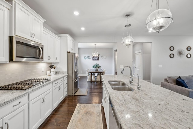 1151 Cotillion Dr, Murfreesboro, TN 37128 - kitchen with stainless steel appliances, a sink, dark wood-style floors, decorative backsplash, and white cabinets