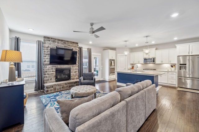 1151 Cotillion Dr, Murfreesboro, TN 37128 - living room with a ceiling fan, dark wood finished floors, recessed lighting, and a stone fireplace