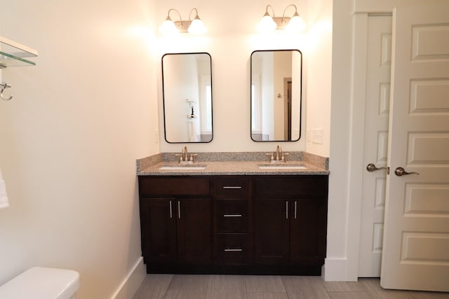 4802A Illinois Ave, Nashville, TN 37209 - bathroom with double vanity, toilet, and baseboards