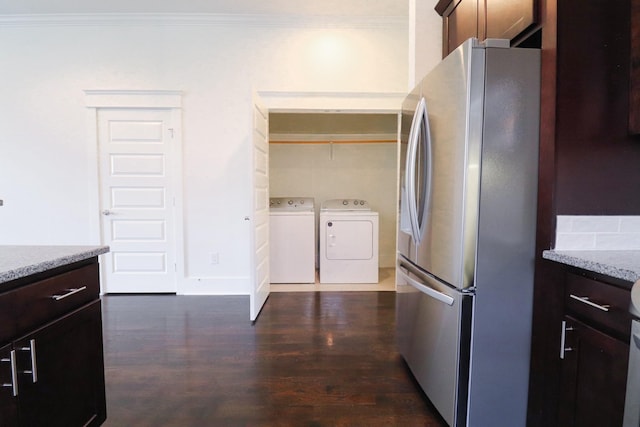 4802A Illinois Ave, Nashville, TN 37209 - kitchen with freestanding refrigerator, washer and clothes dryer, dark wood-style floors, ornamental molding, and light stone counters