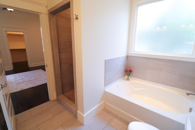 4802A Illinois Ave, Nashville, TN 37209 - bathroom with a garden tub, baseboards, tile patterned floors, a tile shower, and toilet