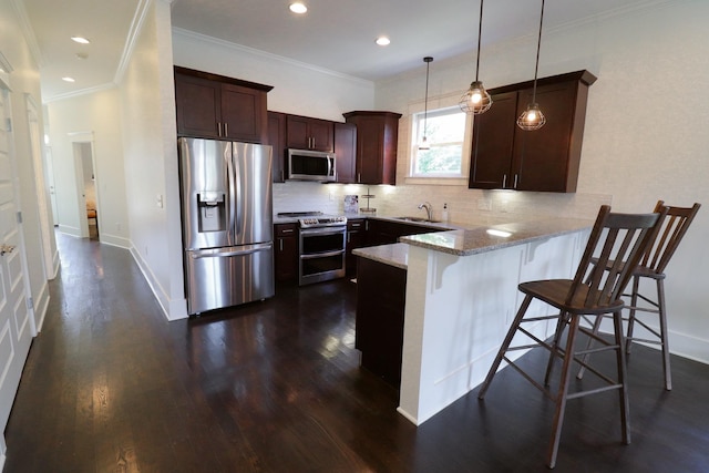 4802A Illinois Ave, Nashville, TN 37209 - kitchen with stainless steel appliances, a peninsula, dark wood-style flooring, backsplash, and recessed lighting