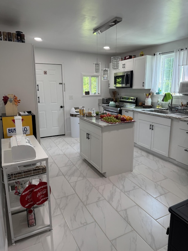 329 Queen Ave, Nashville, TN 37207 - kitchen featuring appliances with stainless steel finishes, light marble finish floors, plenty of natural light, white cabinets, and recessed lighting