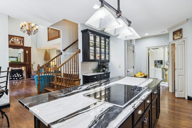314 W 6th St Unit 7, Columbia, TN 38401 - kitchen featuring black electric stovetop, dark wood finished floors, glass insert cabinets, a chandelier, and recessed lighting