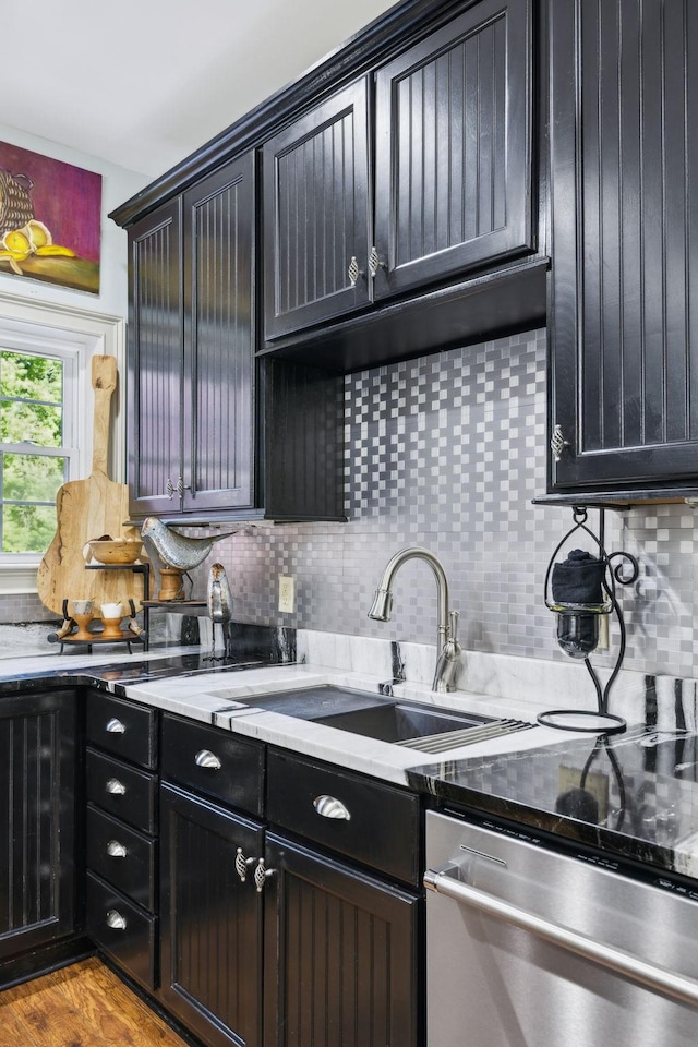 314 W 6th St Unit 7, Columbia, TN 38401 - kitchen with dishwasher, a sink, backsplash, light countertops, and dark cabinetry