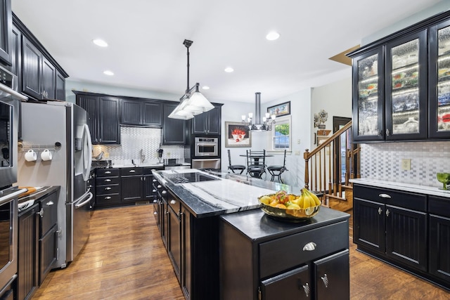 314 W 6th St Unit 7, Columbia, TN 38401 - kitchen with a kitchen island with sink, dark cabinetry, tasteful backsplash, and recessed lighting