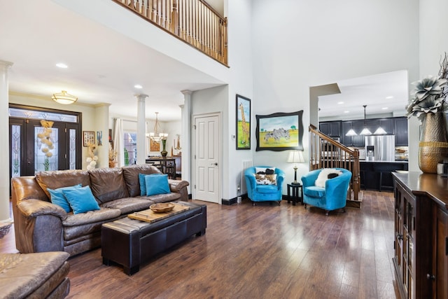 314 W 6th St Unit 7, Columbia, TN 38401 - living area with a chandelier, dark wood-style floors, a high ceiling, decorative columns, and stairs