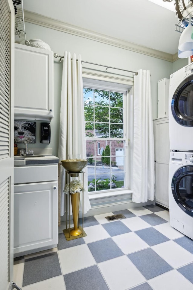 314 W 6th St Unit 7, Columbia, TN 38401 - washroom featuring stacked washer / dryer, tile patterned floors, crown molding, and cabinet space