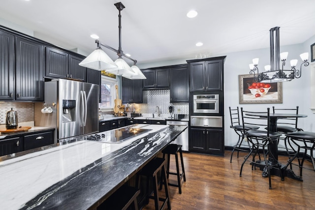 314 W 6th St Unit 7, Columbia, TN 38401 - kitchen with stainless steel appliances, a kitchen bar, a warming drawer, recessed lighting, and dark wood-style flooring